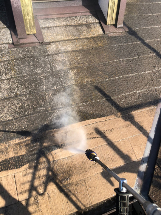 高圧洗浄を行います。<br />
屋根塗装における高圧洗浄作業は、せっかく塗装した塗料がたった数年で剥がれてしまわないように、屋根の表面にある古い塗膜を取り除くために行います。